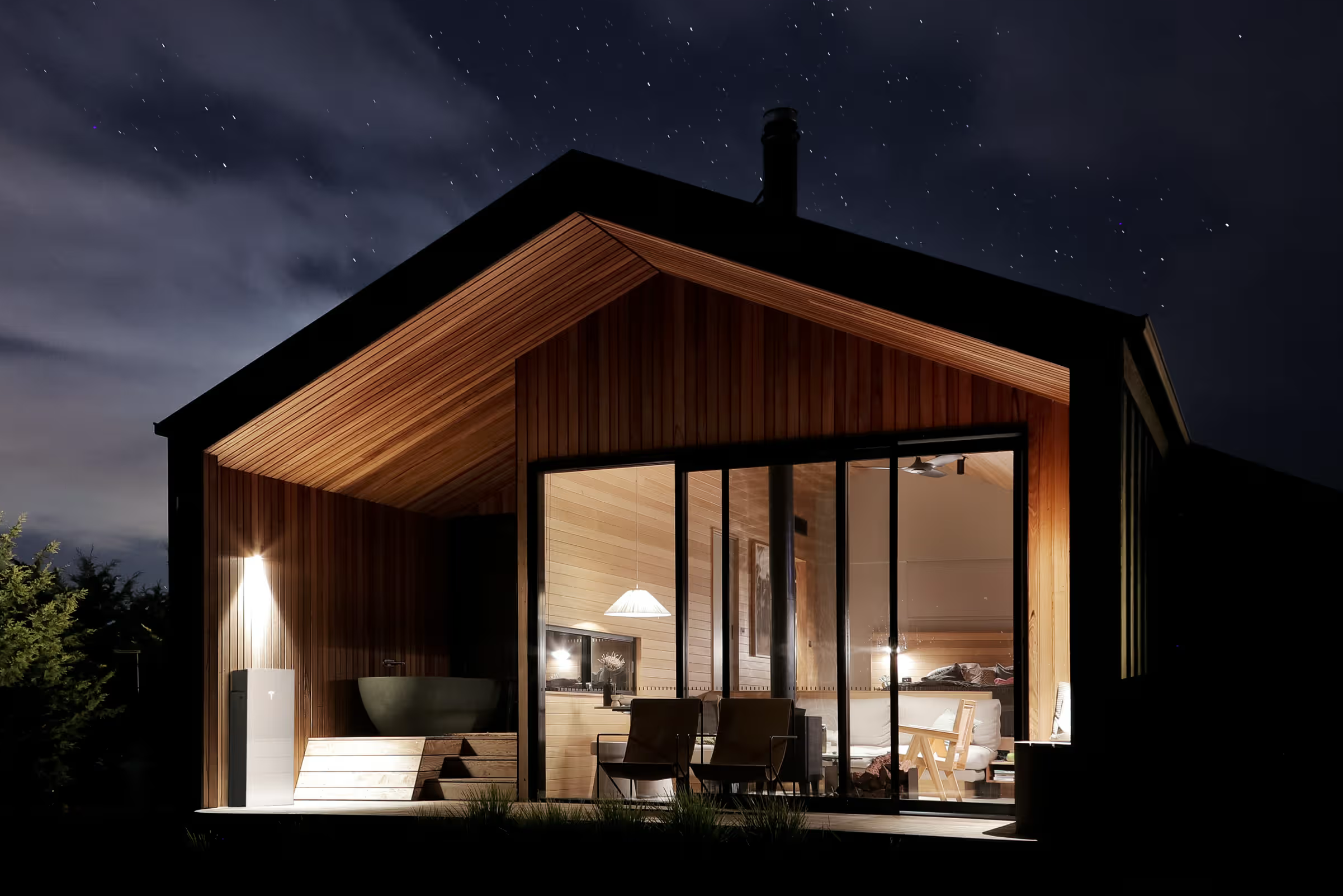 Tesla Powerwall home battery installed on the side of a modern home